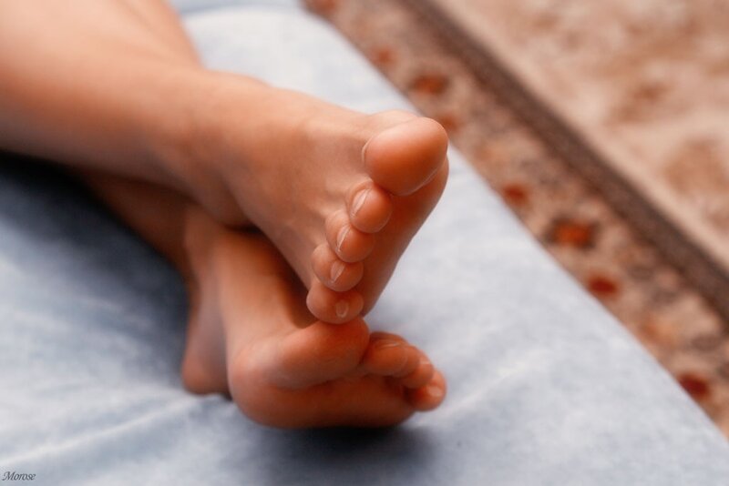 feet on a blue surface