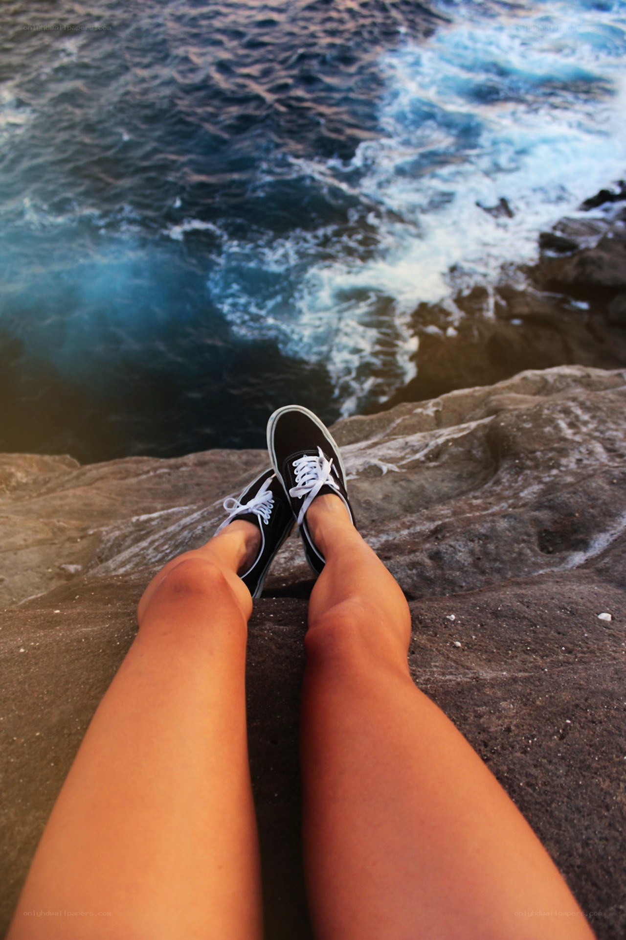 feet on a rocky cliff