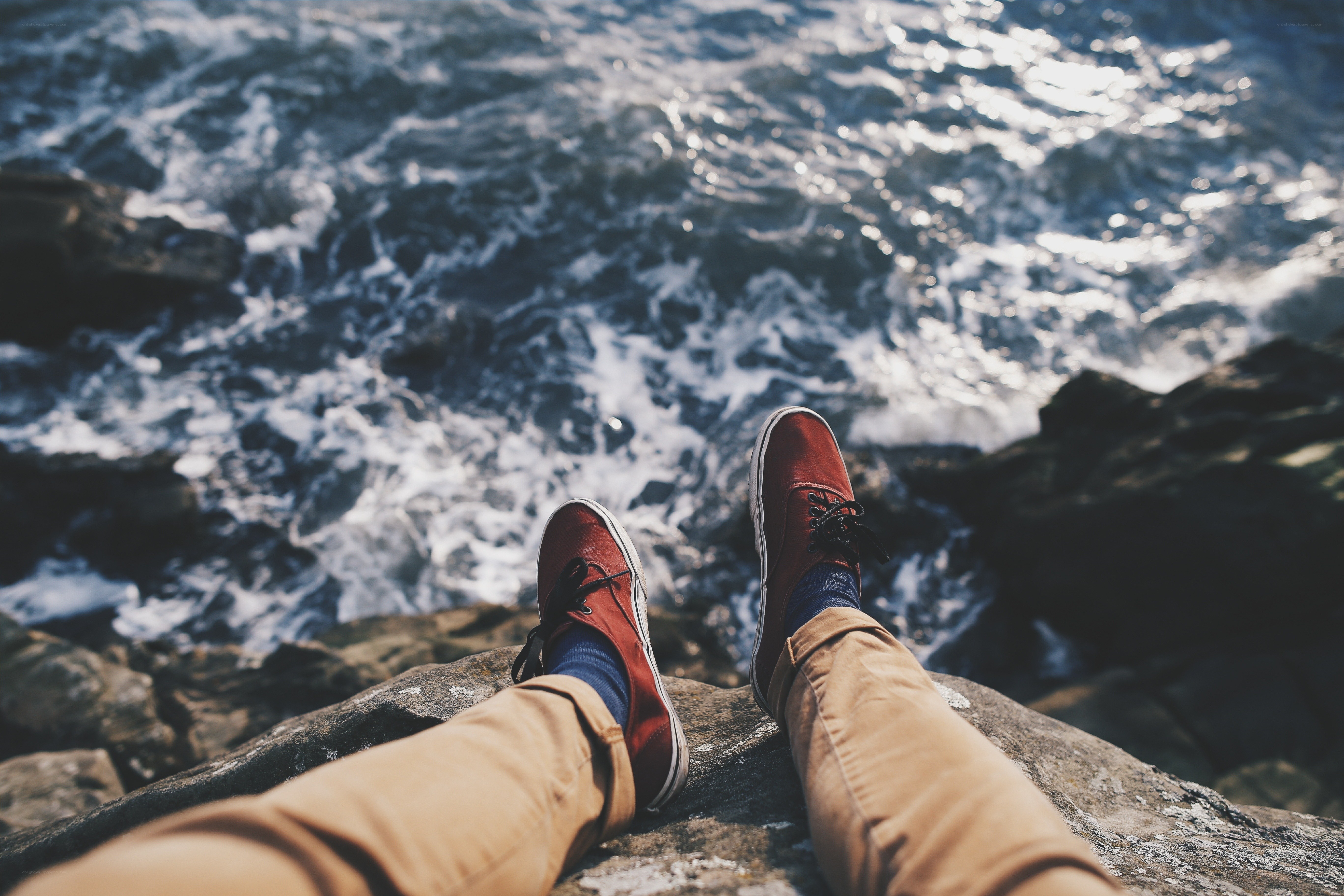 feet on a rocky cliff