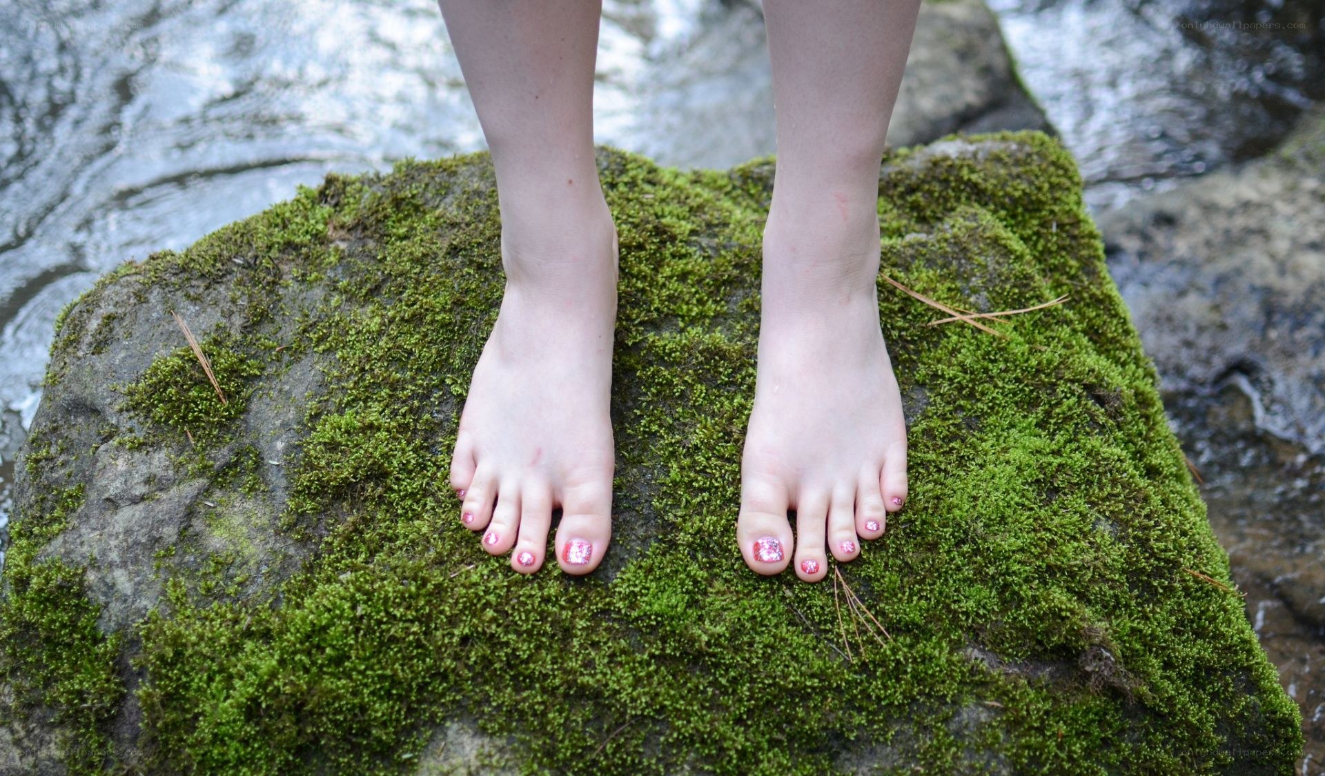 feet on mossy rock