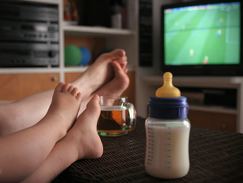 Feet on table with baby bottle