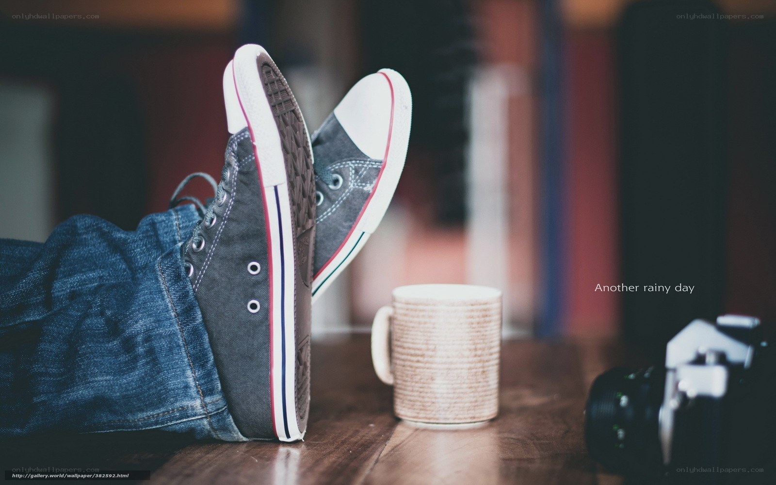 feet on table with mug and camera