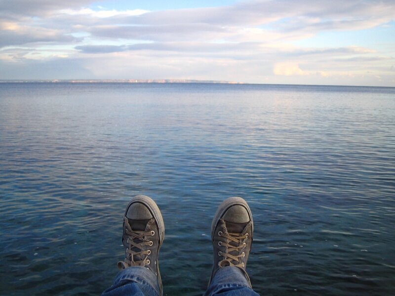 Feet on the edge of a pier