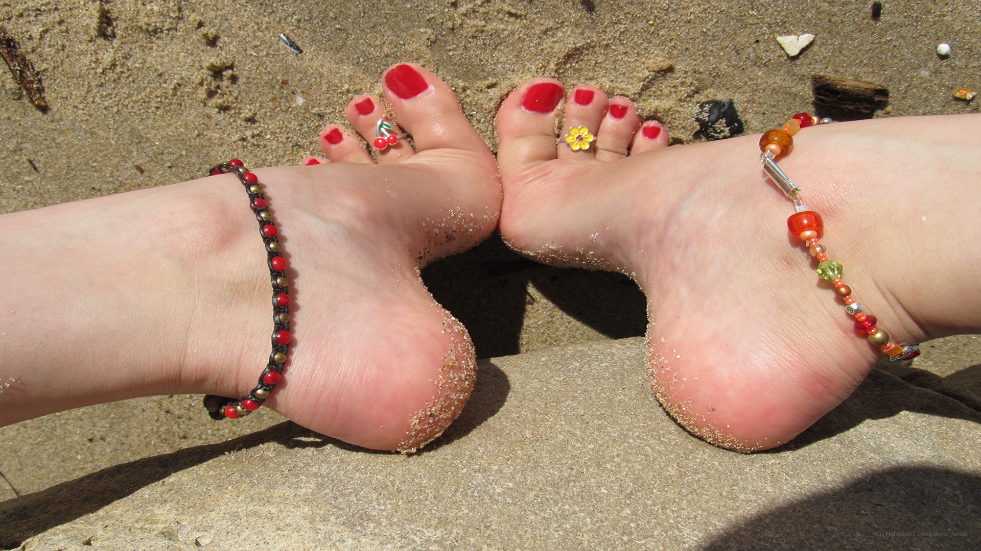 feet on the sandy beach