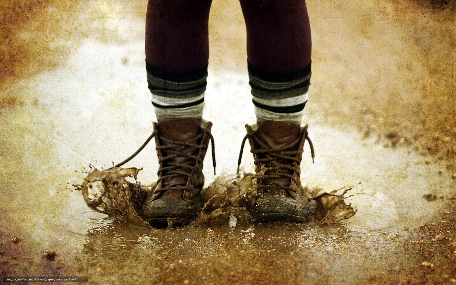 feet splashing in a muddy puddle