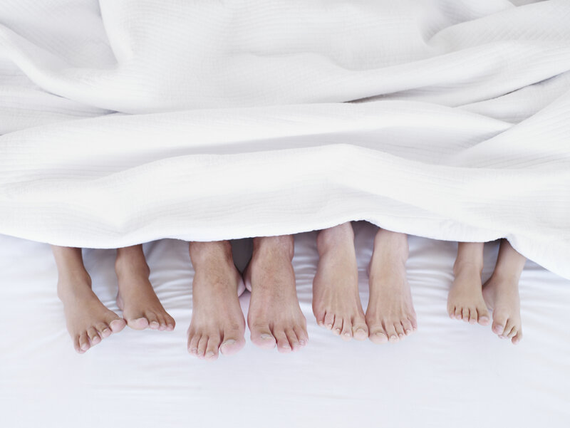Feet under Blanket — White