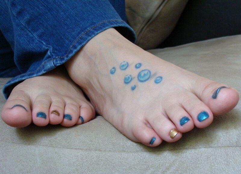 feet with nail polish and tattoo