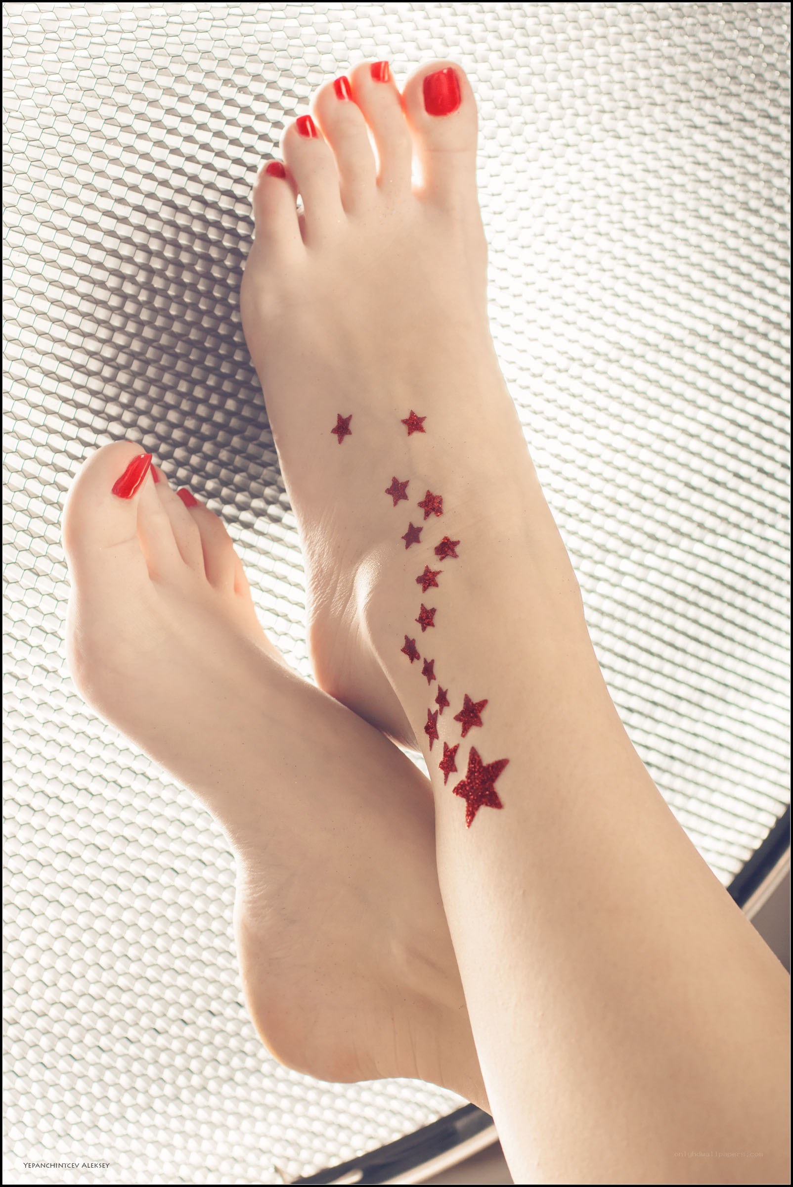 feet with red star tattoos