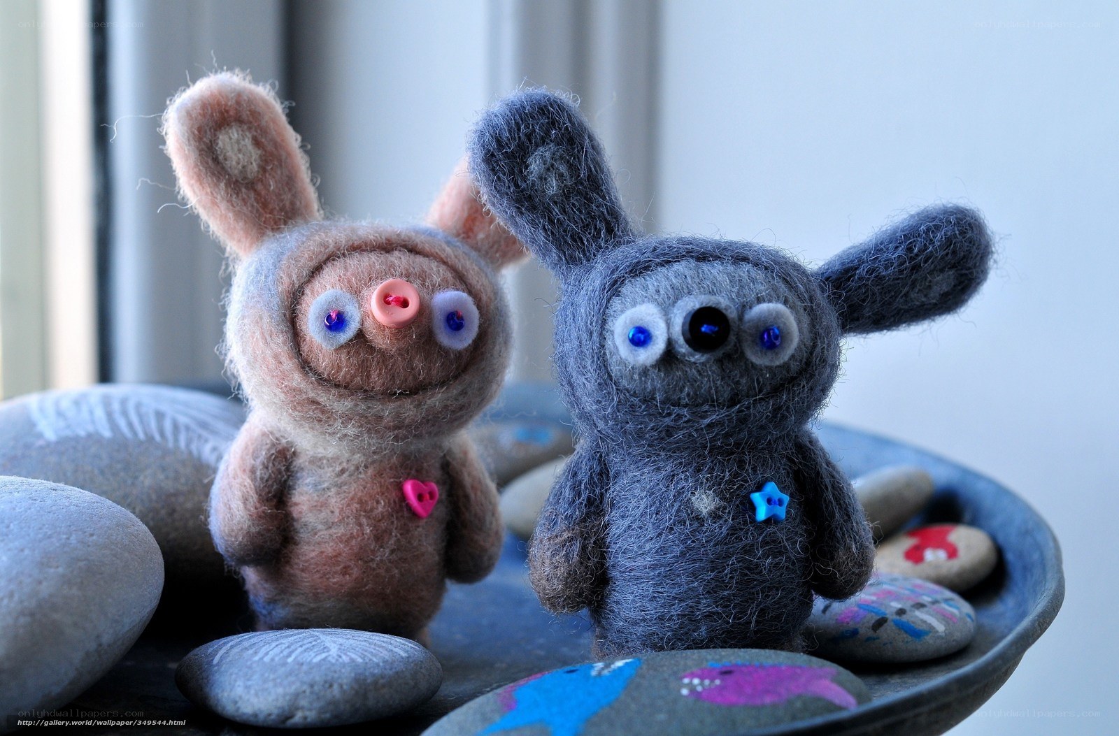 Felt toy figures on stones