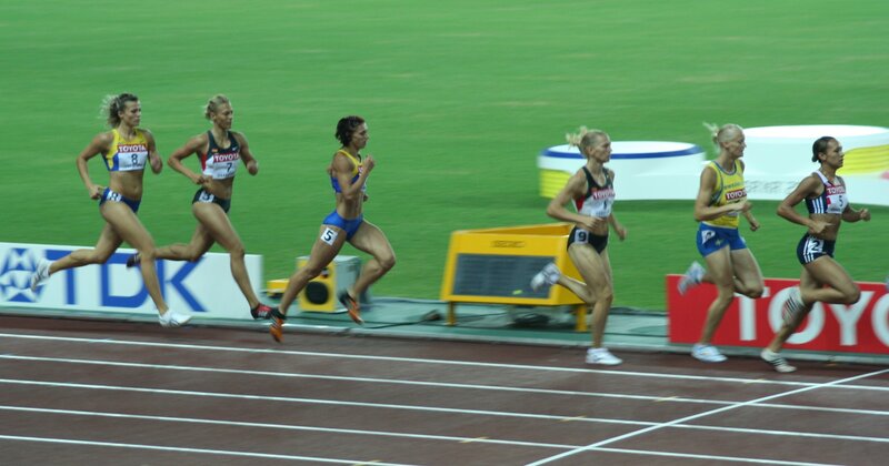 Female athletes running on a track