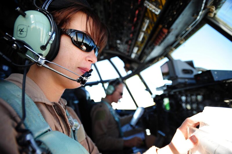 Female Pilot in Cockpit — Brown