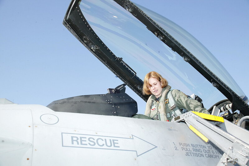 Female pilot in fighter jet cockpit