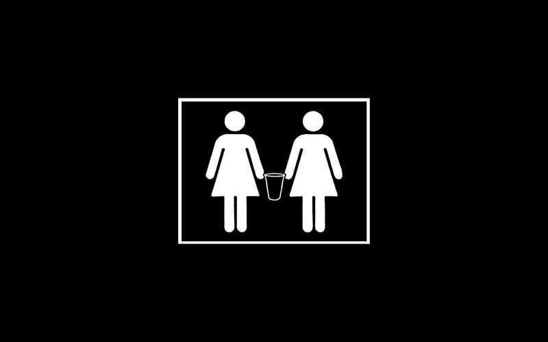 female restroom sign with trash can