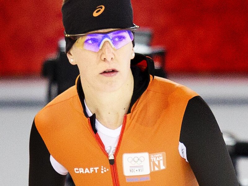 Female Speed Skater — Orange, Focused, Photograph
