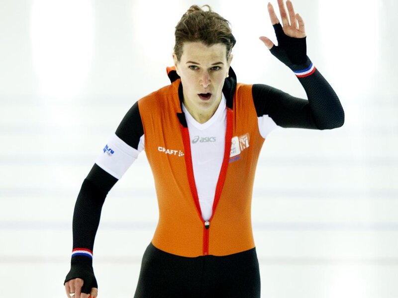 Female Speed Skater — Orange, Intense, Photograph