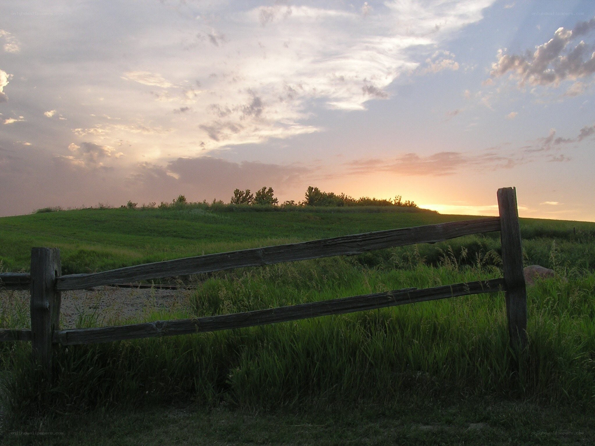 Fence at sunset on a hill