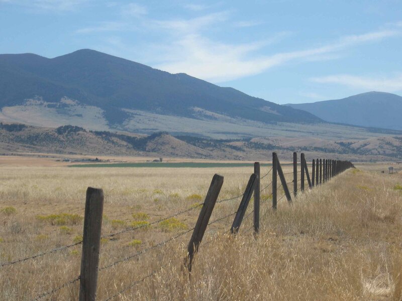 fenced field with mountains