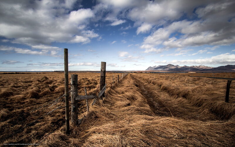 Fenced field with mountains
