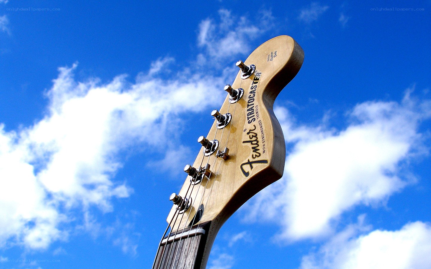 Fender Stratocaster headstock against sky
