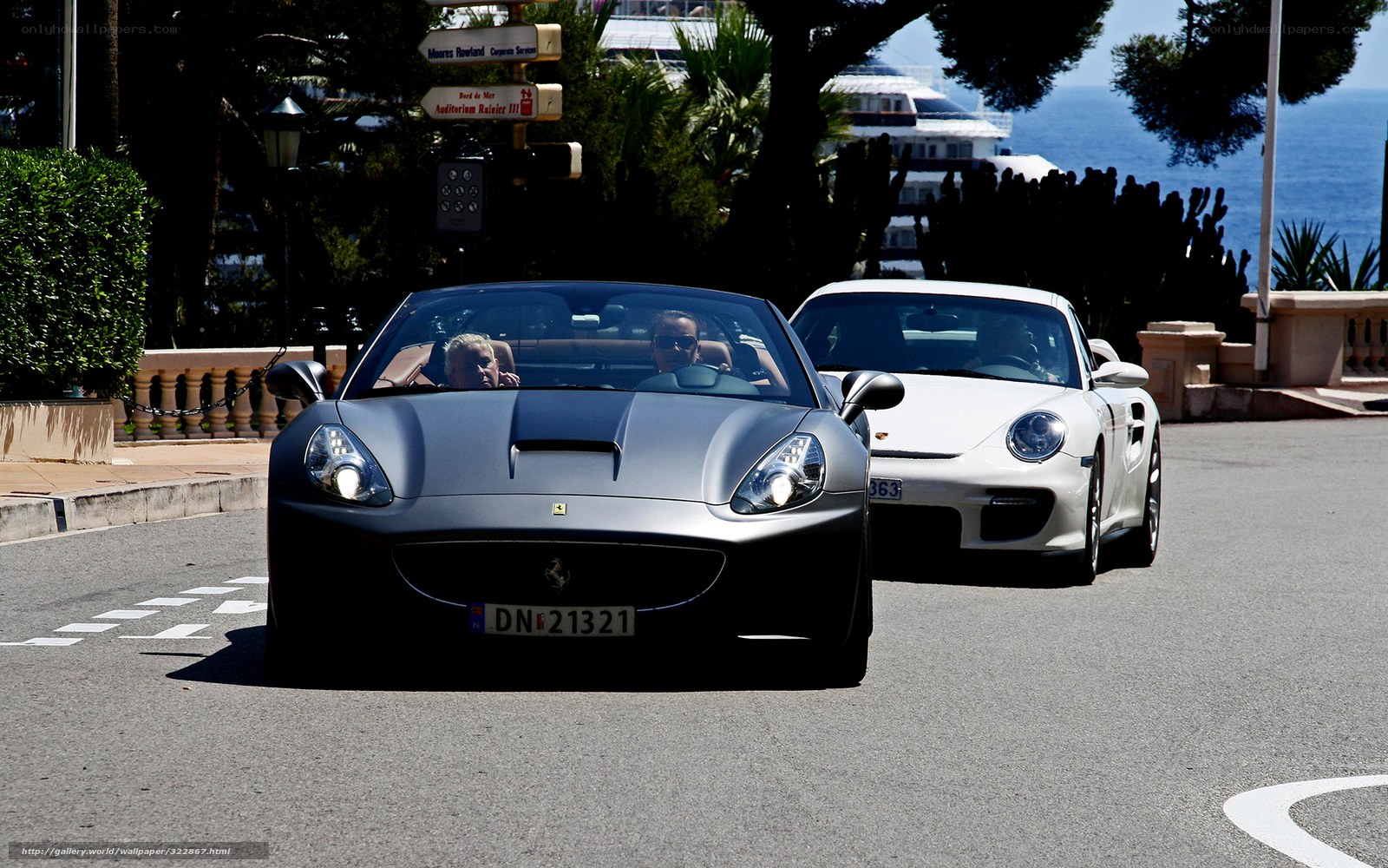 Ferrari and Porsche on coastal road