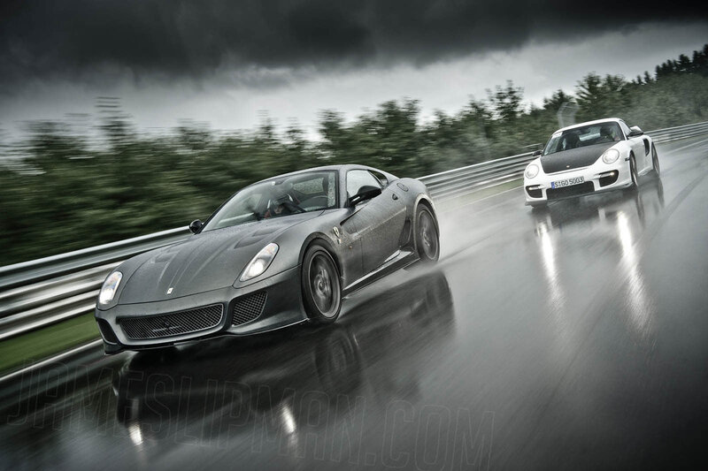 Ferrari and Porsche racing on wet track