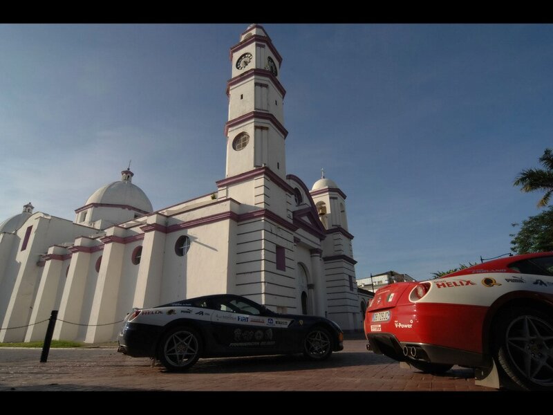 Ferrari cars in front of a church
