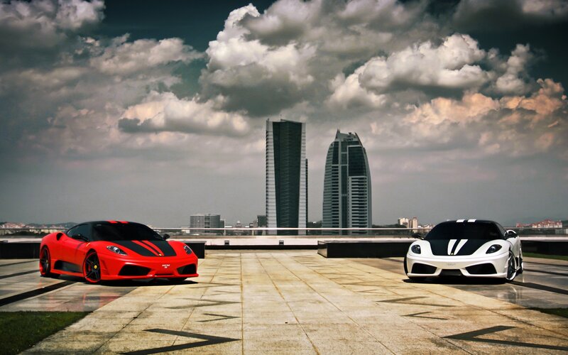 Ferrari cars on a city rooftop