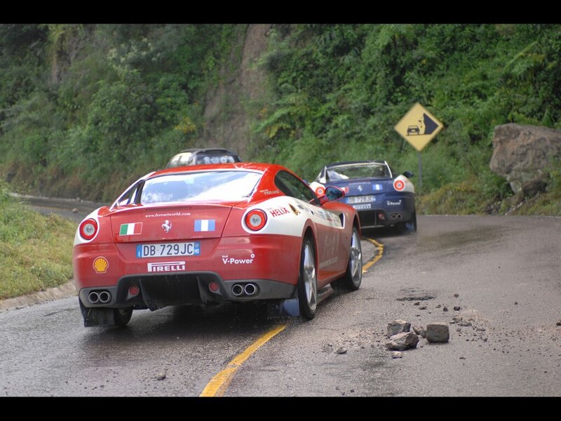 Ferrari cars on a winding road
