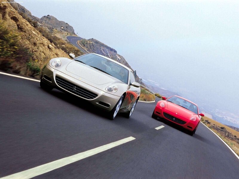 Ferrari cars on a winding road