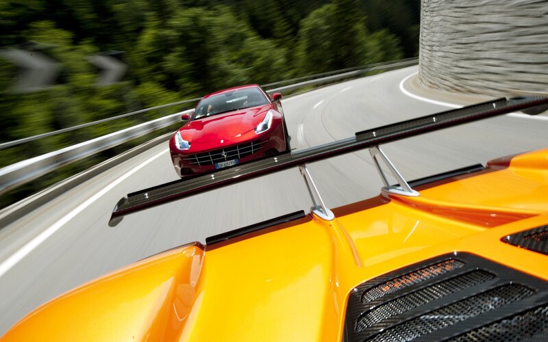 Ferrari cars on winding road