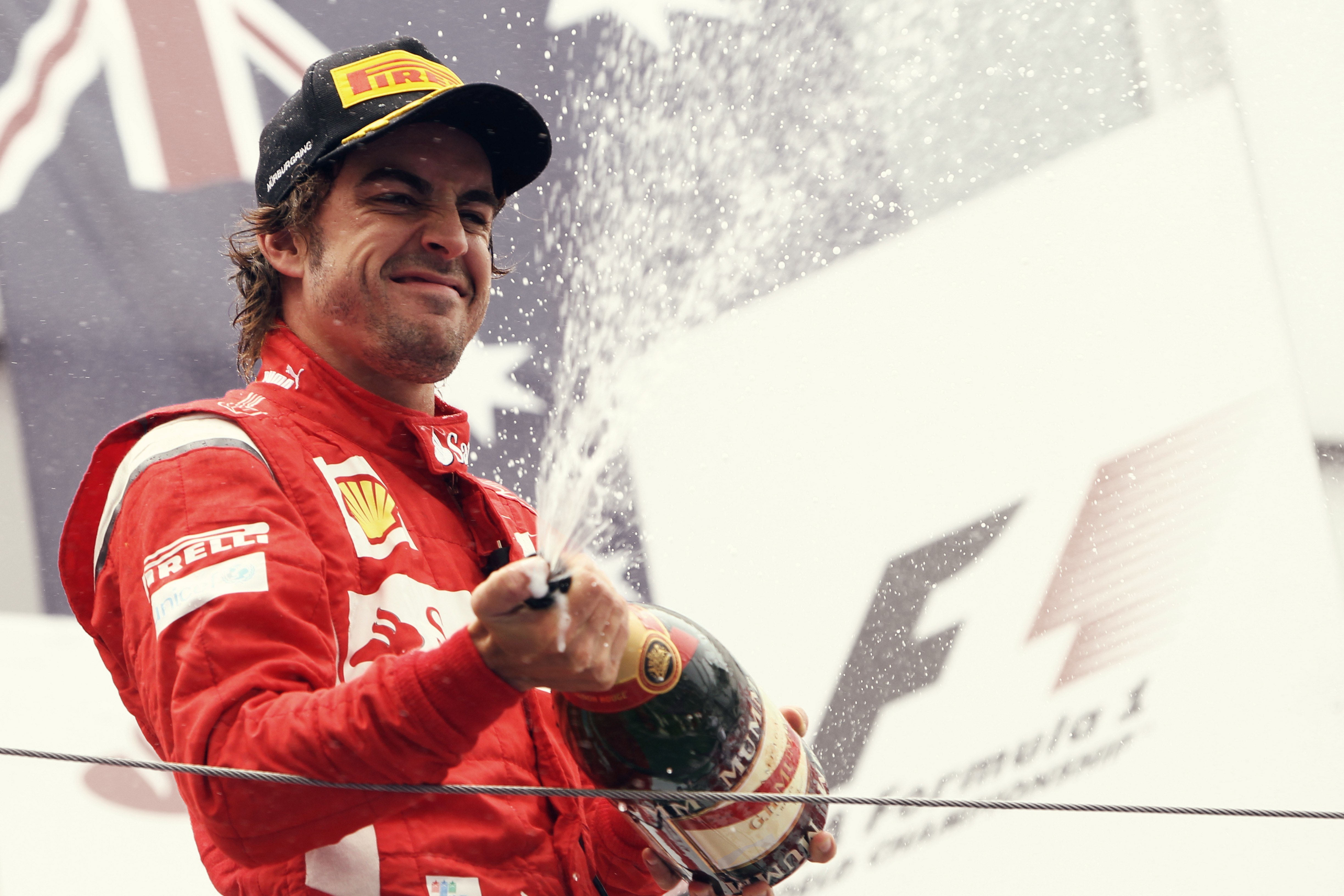 Ferrari driver celebrating on podium