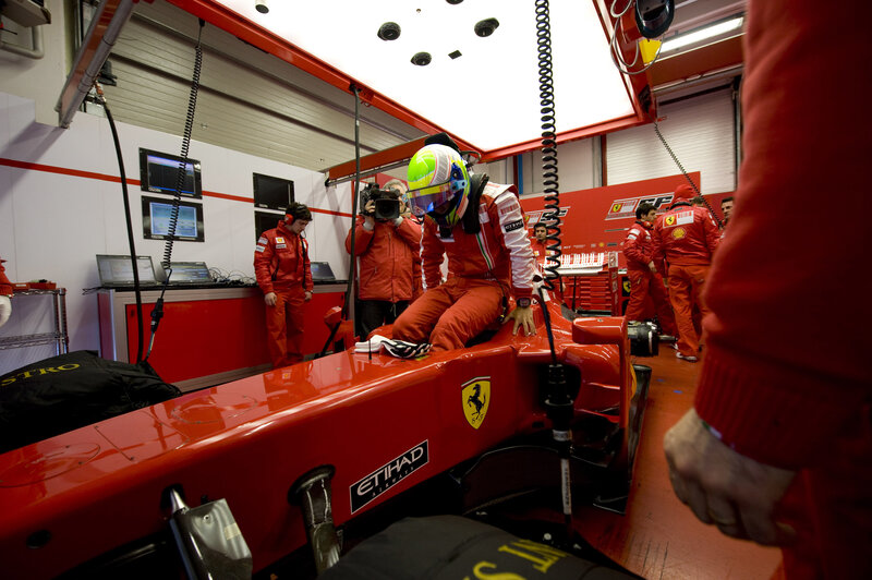Ferrari driver in pit garage