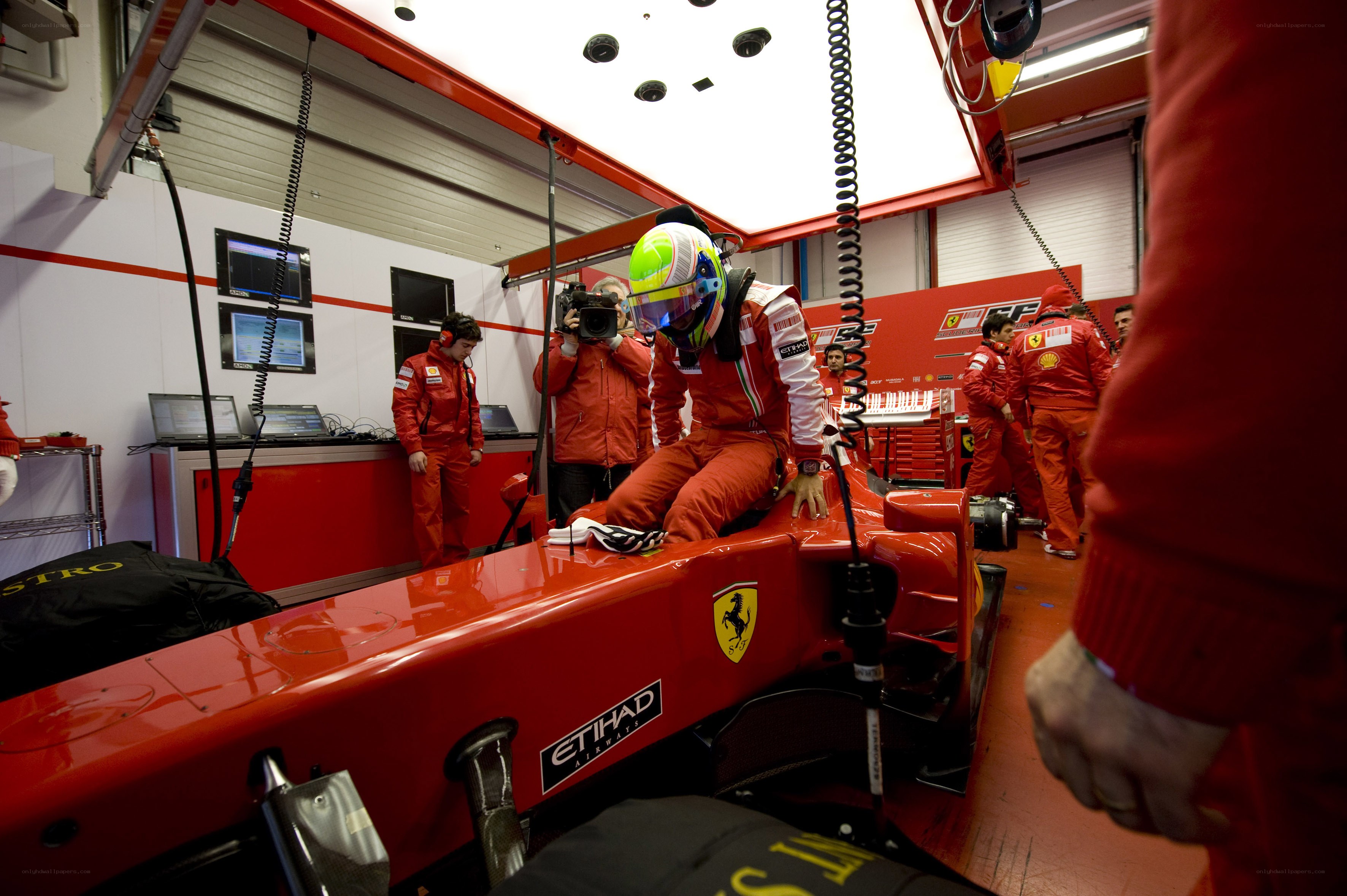 Ferrari driver in pit garage
