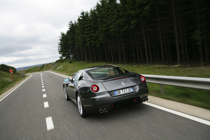 Ferrari driving on a winding road