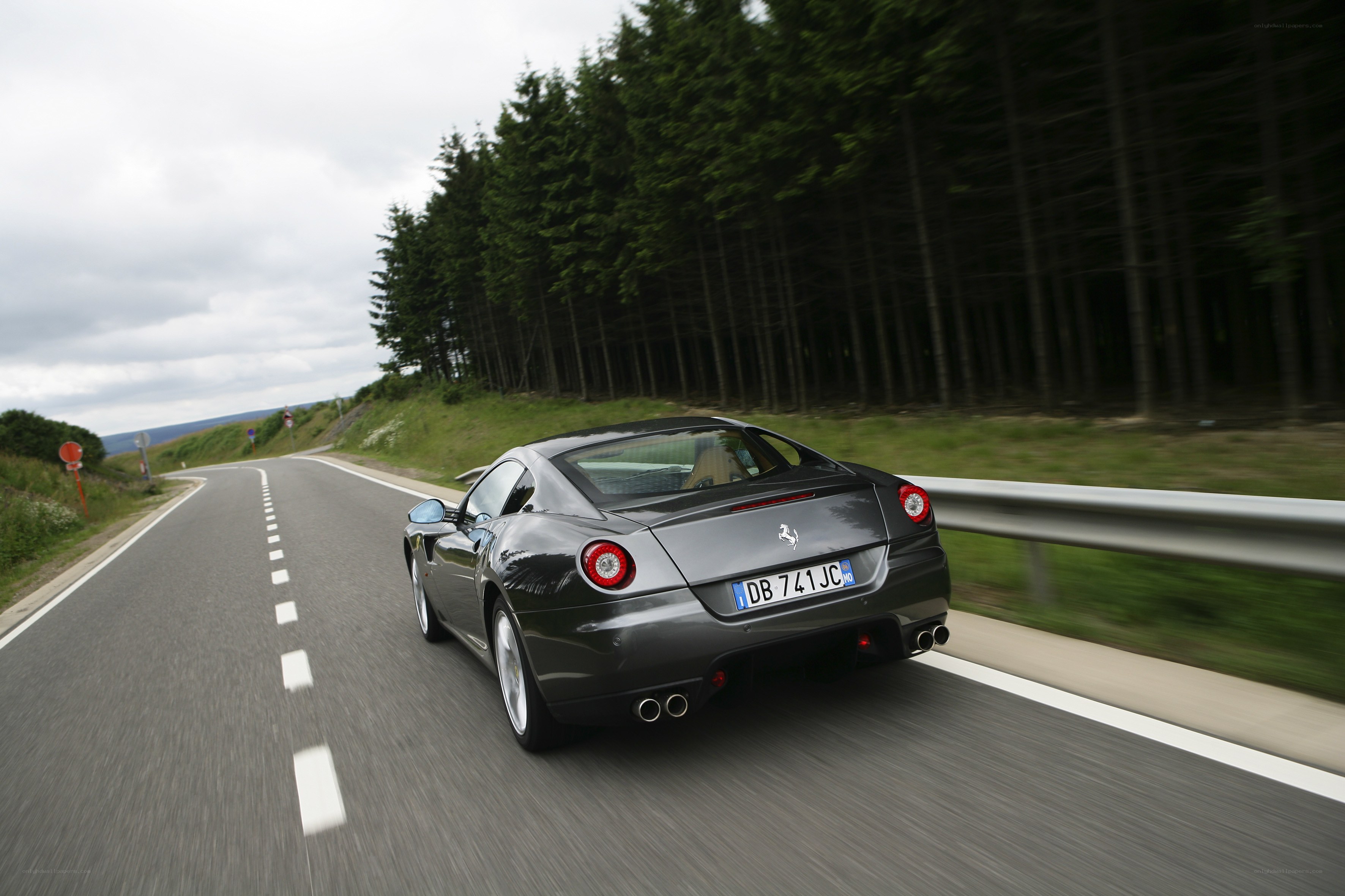 Ferrari driving on a winding road