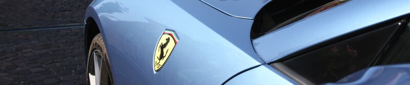 Ferrari emblem on blue car