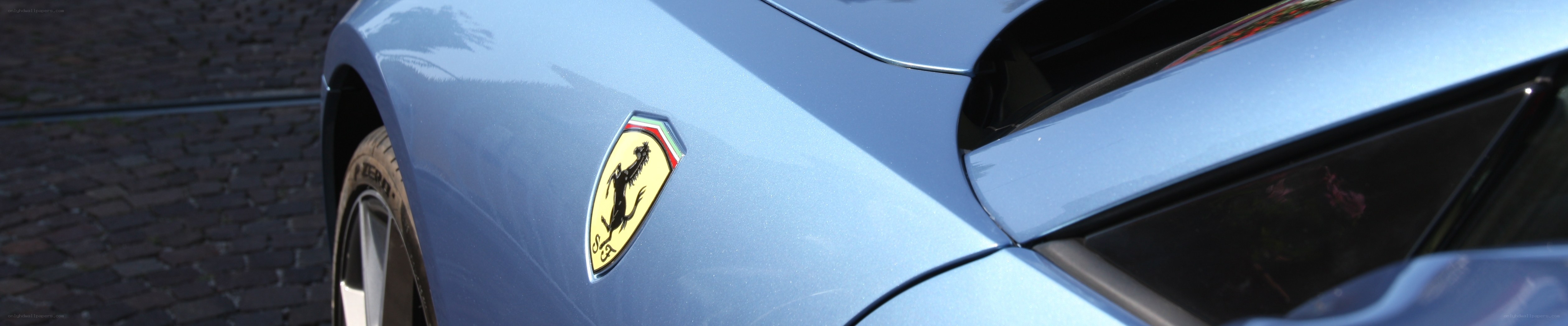 Ferrari emblem on blue car