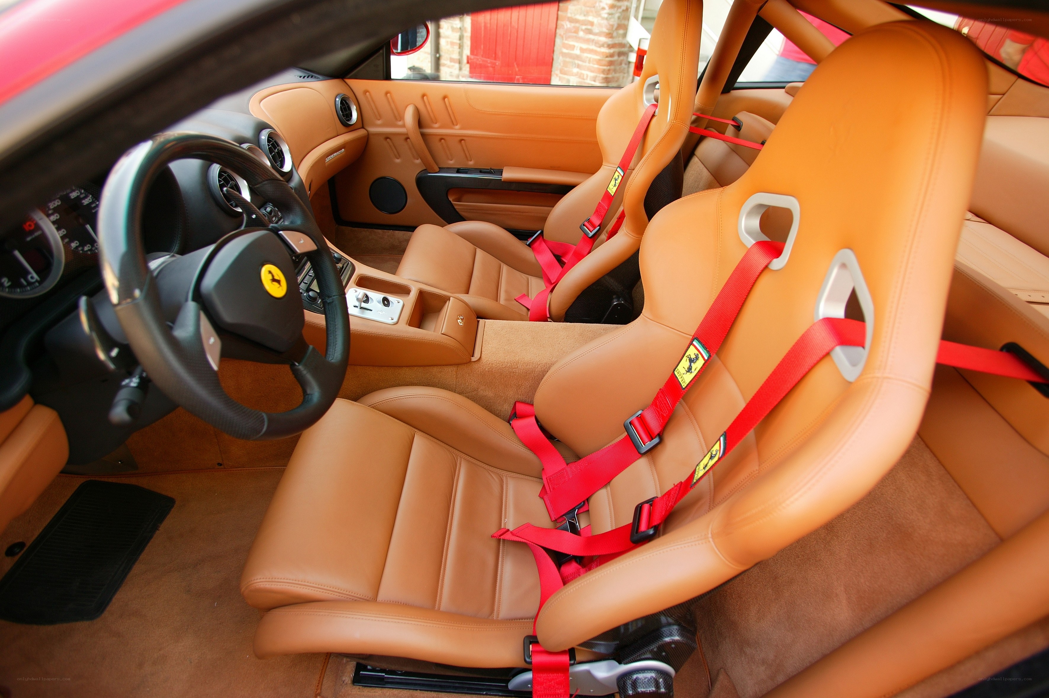 Ferrari interior with red harnesses