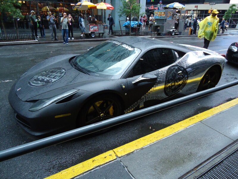 Ferrari on a rainy city street