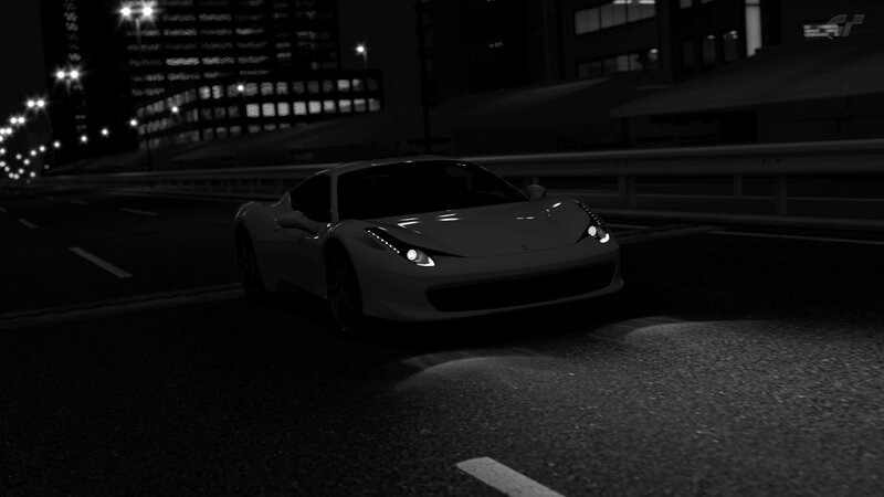 Ferrari on city street at night