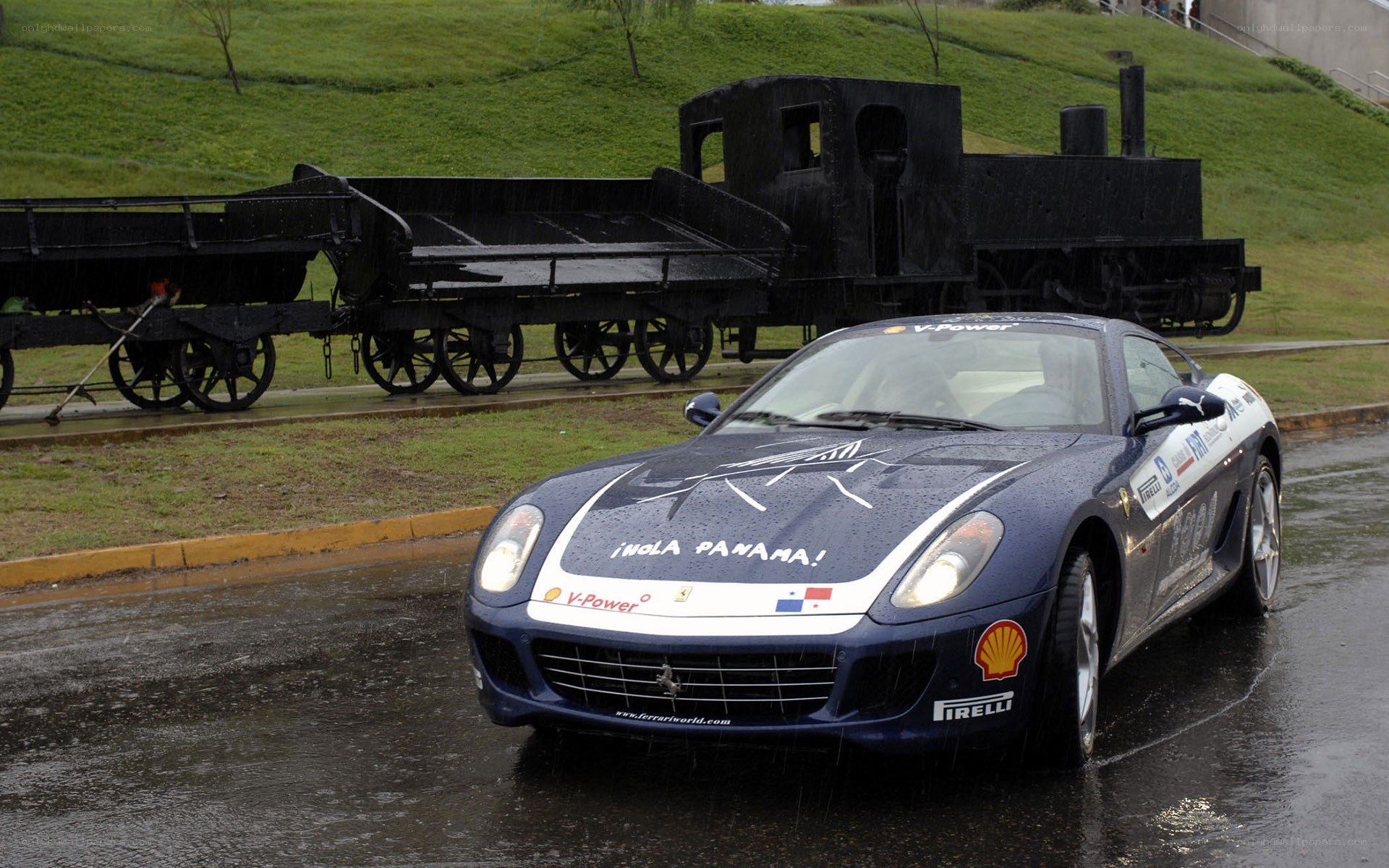 Ferrari on wet road with train