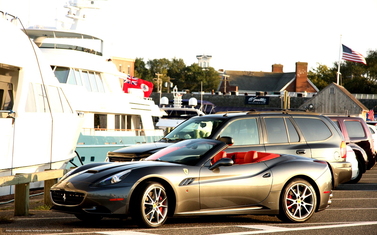 Ferrari parked near yachts