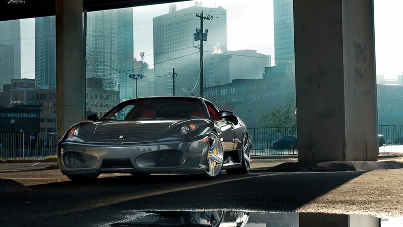 Ferrari parked under a bridge