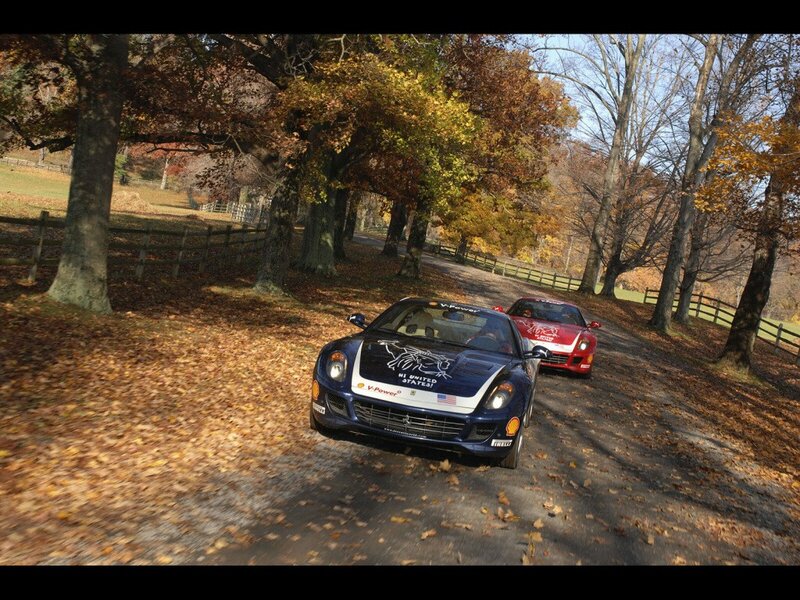 Ferrari race cars on a leafy road