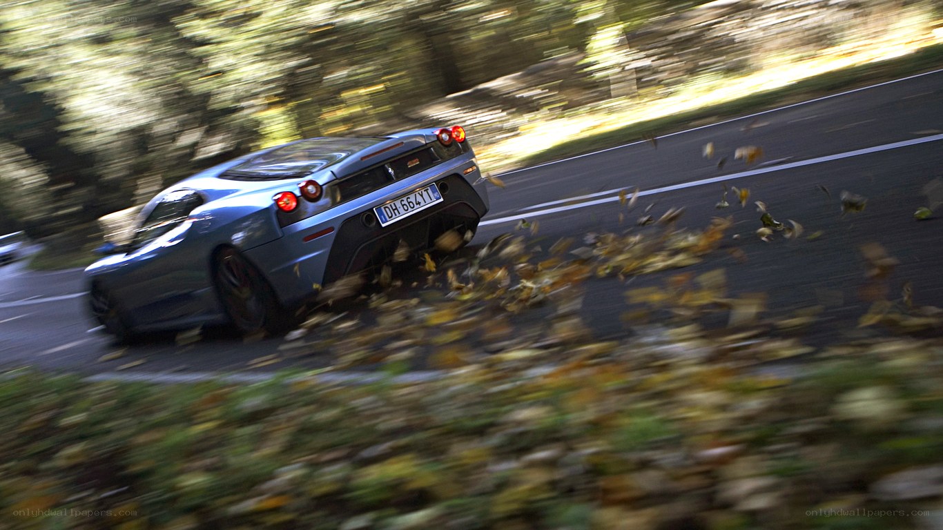 Ferrari speeding on autumn road