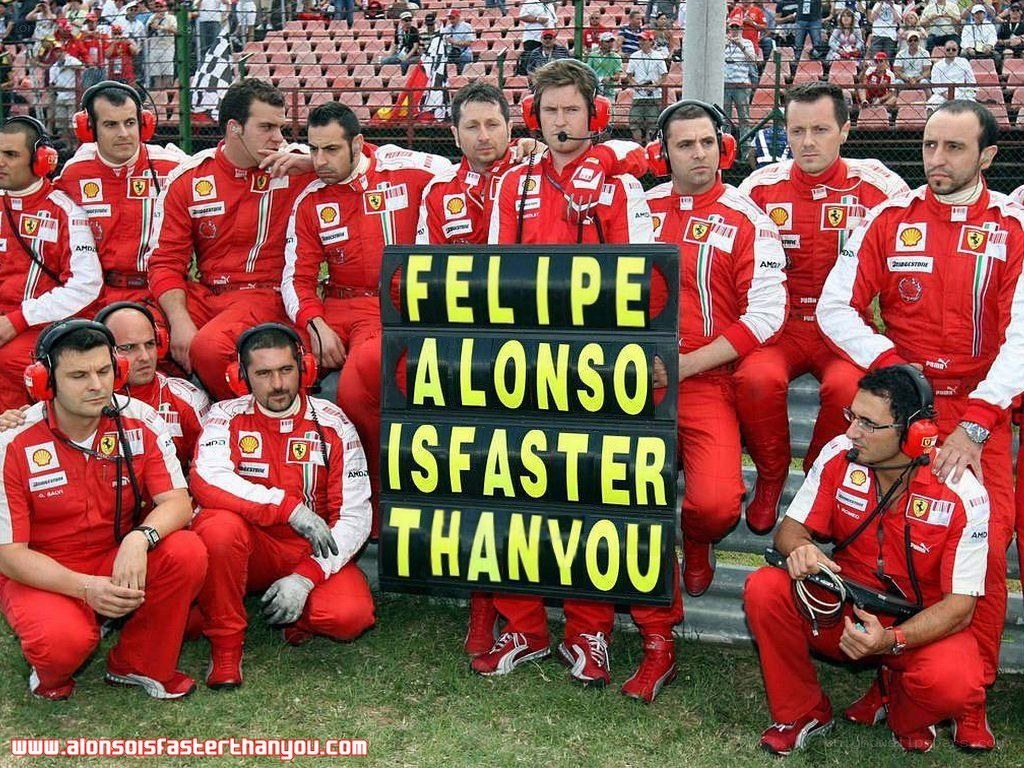 Ferrari team with sign