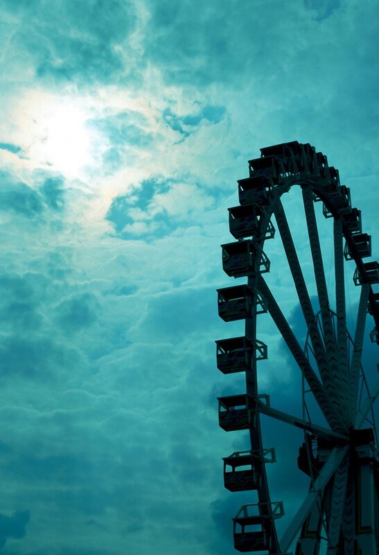 Ferris wheel against cloudy sky