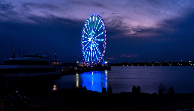 Ferris wheel at dusk by the water