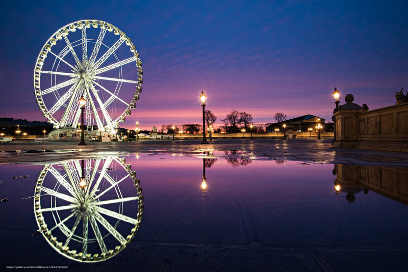 Ferris wheel at dusk with reflection