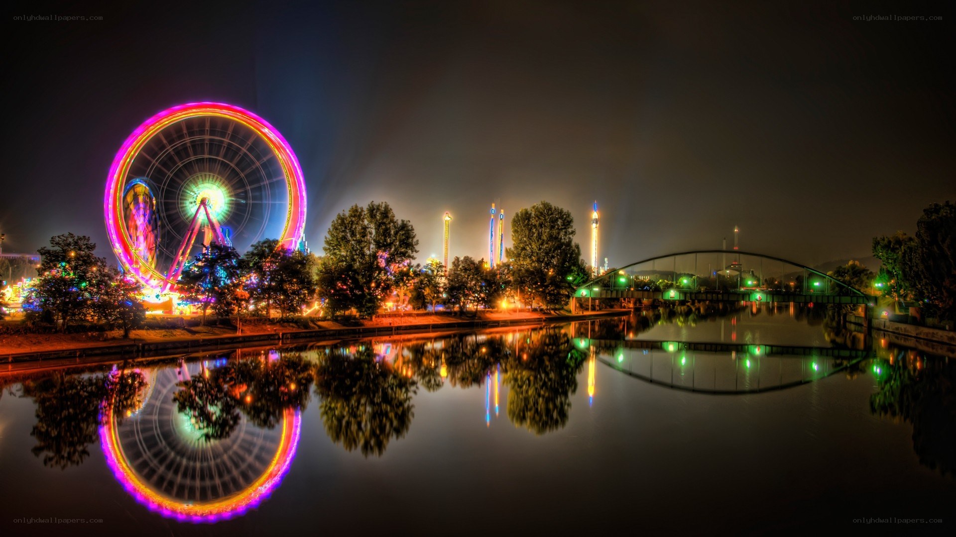 Ferris wheel at night by the river